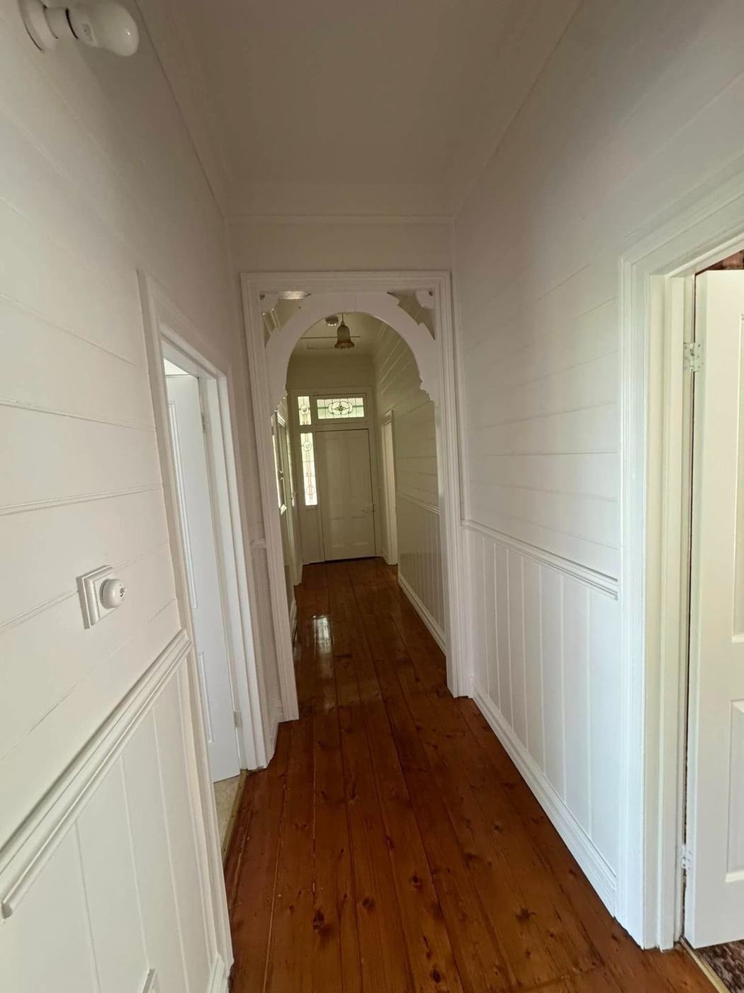 Hallway with archway and wainscoting